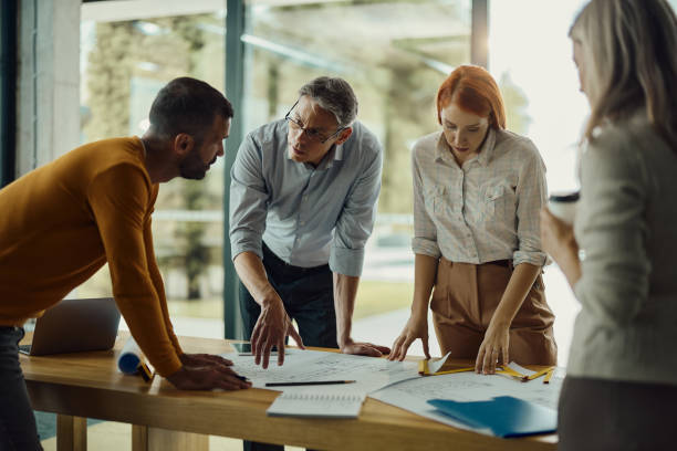 istock Building contractors working on plans in the office. 1439681632