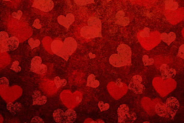 istock Grunge red background with heart shapes 1439681681