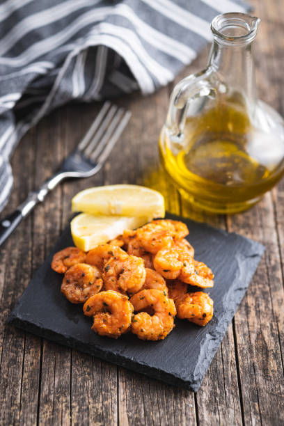 istock Grilled tiger shrimps on wooden table. 1439681795