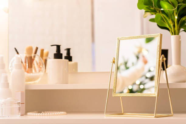istock Reflection of christmas tree, light bulbs, in table mirror on woman dressing table with make up accessories 1439681798
