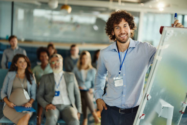 istock Happy male CEO drawing plans during presentation in board room. 1439682374