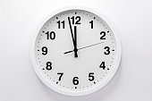 istock Simple analog wall clock on white background. 1439682573