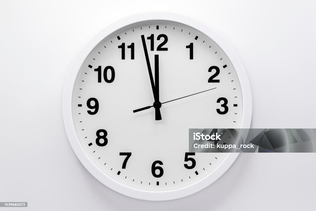Simple analog wall clock on white background. Clock Stock Photo
