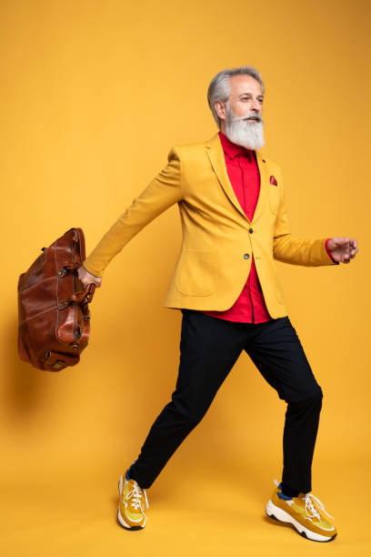 istock Happy well dressed gentleman having photoshooting in studio 1439686077