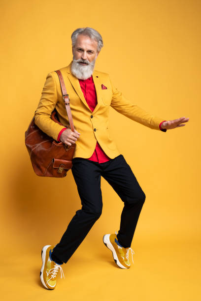 istock Happy well dressed gentleman having photoshooting in studio 1439686117
