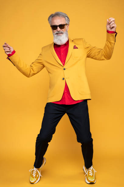 istock Happy well dressed gentleman having photoshooting in studio 1439686120