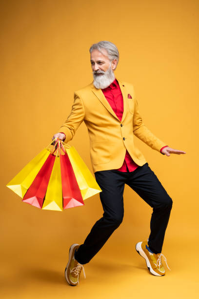istock Happy well dressed gentleman having photoshooting in studio 1439686131