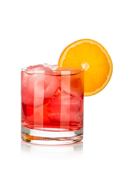istock red drink with ice cubes and orange slice on white background, isolated 1439688851