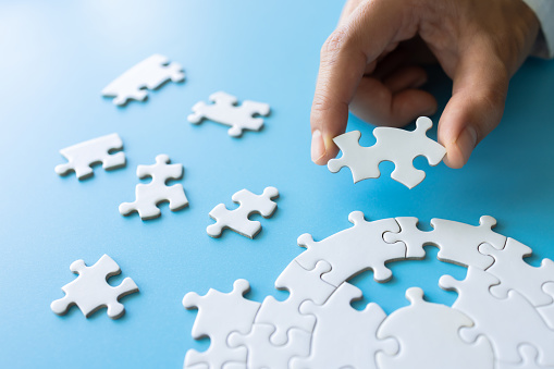 Hand put the last piece of jigsaw puzzle to complete the mission, Business solutions, success and strategy concept