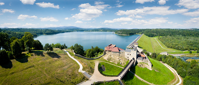 A water dam with a power plant and ruins of medieval castle on Lake Dobczyce in Malopolska province, Poland