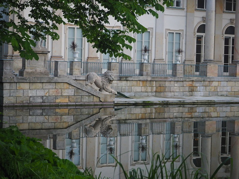 Warsaw, Poland, June 8, 2022: azienki Bath Palace architecture details mirror in the water