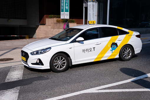 Seoul, South Korea - October 27, 2022: A Kakao Taxi moves on a street. Kakao is the developer of several popular and integral apps in the country, including ride-hailing and messaging apps.