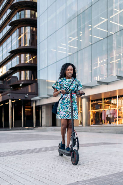 fille africaine conduisant un scooter électrique - love smiling human settlement viewpoint photos et images de collection