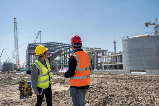 istock Two engineers are working at the construction site of the chemical plant under construction 1439693673