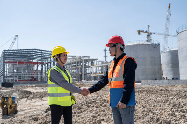 istock Two engineers are working at the construction site of the chemical plant under construction 1439693676