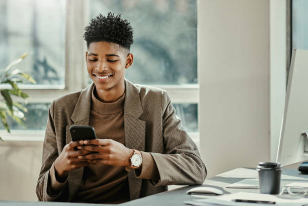 istock Smartphone, business and technology of man typing in office for networking, reading email on mobile app or to check finance app. Digital marketing employee with computer and using phone for ecommerce 1439694906