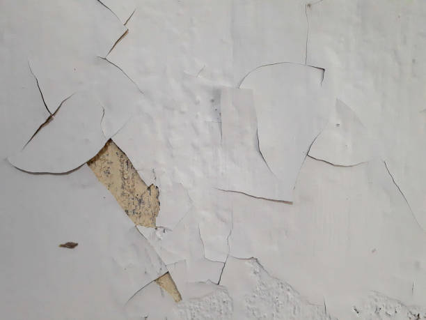 istock Close up of a white wall background with peeling paint 1439695134