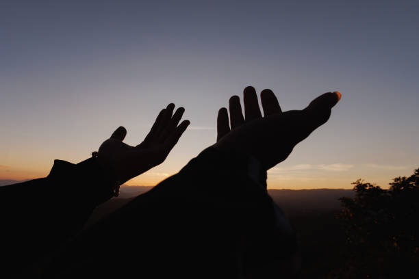 silhouette der menschlichen hände öffnen handfläche nach oben anbetung. eucharistietherapie segne gott hilfe buße katholische ostern fastenzeit geist beten. hintergrund des konzepts der christlichen religion. kampf und sieg für gott. - god freedom arms raised high angle view stock-fotos und bilder