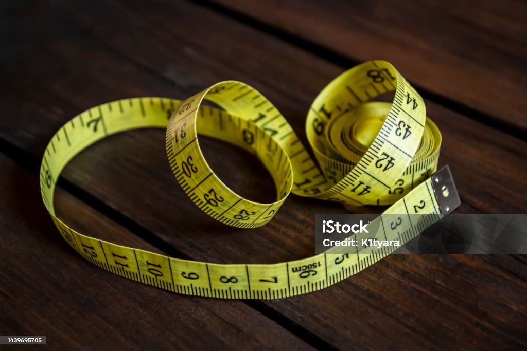 https://media.istockphoto.com/id/1439695705/photo/on-the-table-is-a-yellow-sewing-meter-seamstress-meter-for-measuring-the-length-and-volume-of.jpg?s=1024x1024&w=is&k=20&c=LswSZTaE-qU-9Q91OtK0bEZiuFxc1DVEH9-nPunrtuo=
