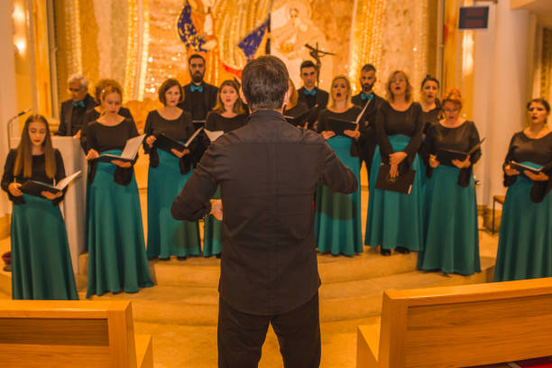 istock Choir practice before the performance in the cathedral with the musical conductor 1439696471