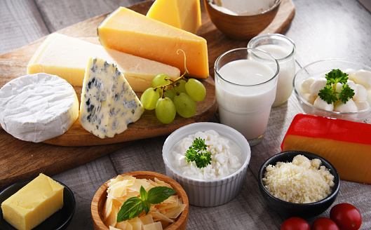 A variety of dairy products including cheese, milk and yogurt.