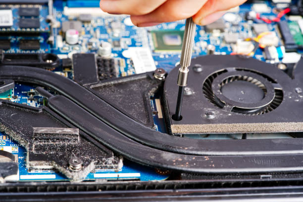 istock Man disassembles a laptop. Computer service and repair concept. Laptop disassembling in repair shop 1439696897