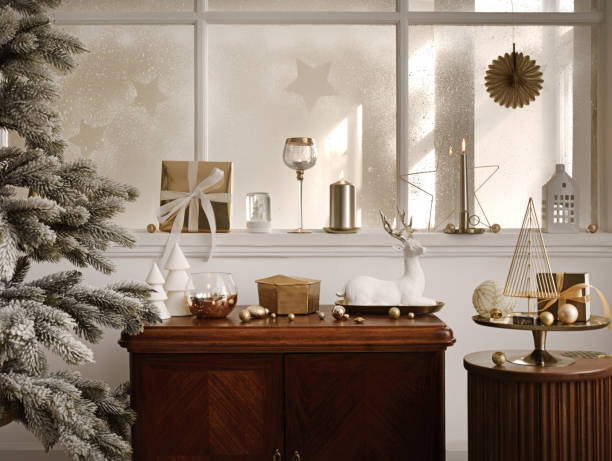 istock Creative composition of living room interior with vintage sideboard, christmas tree, white sculpture, glass candlestick, wooden stand, gifts and personal accessories. Home decor. Template. 1439697066