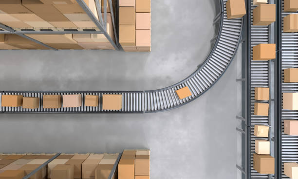 istock Top view of conveyor belts transporting boxes in a large warehouse 1439698043