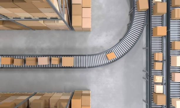 top view of conveyor belts transporting boxes in a large warehouse - löpande band bildbanksfoton och bilder