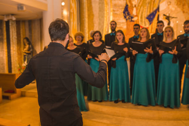 istock Choir practice before the performance in the cathedral with the musical conductor 1439699124