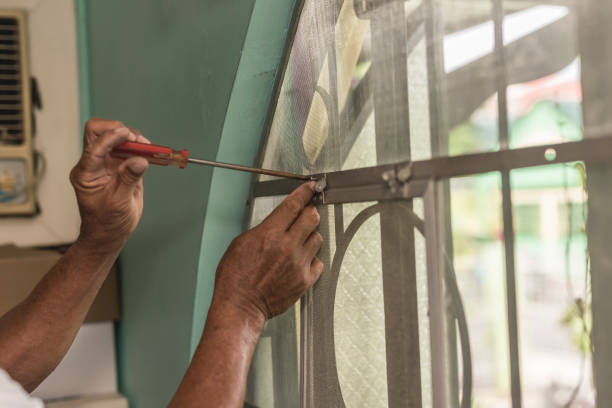 istock A handyman installs a screen mesh frame with a screwdriver on a window at the bedroom. Home renovation concept. 1439699377