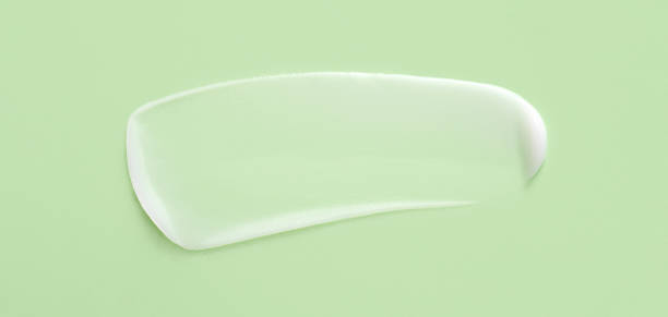 istock cosmetic smears cream texture on pastel green background 1439700406