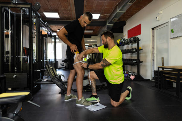 istock Trainer measures with a centimeter tape, in inches, body size. 1439701493