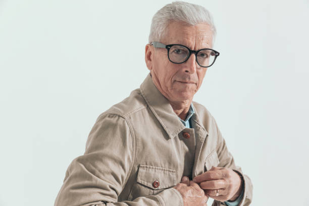 istock casual man in his 60s is closing his jacket 1439703534