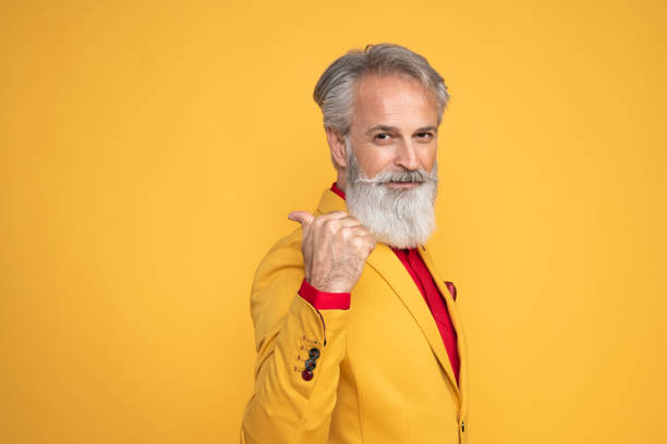 istock Happy well dressed gentleman having photoshooting in studio 1439705476