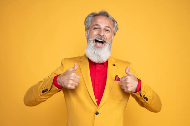 istock Happy well dressed gentleman having photoshooting in studio 1439705496