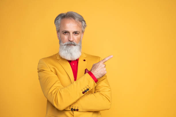 istock Happy well dressed gentleman having photoshooting in studio 1439705497