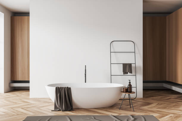 istock Light bathroom interior with bathtub and towel rail ladder. Mockup wall 1439705655