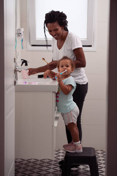 Family brushing teeth in the morning routine. stock photo