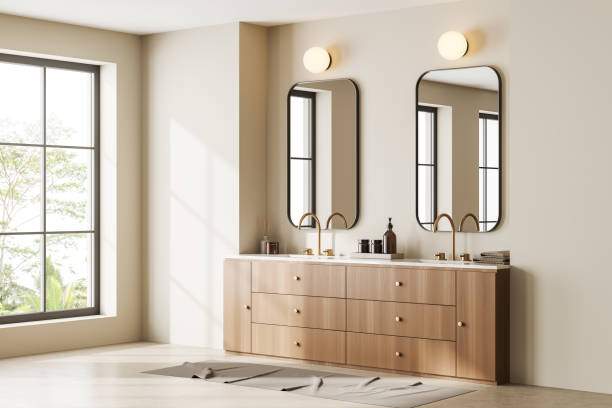istock Beige bathroom interior with two sinks, dresser and window 1439708283