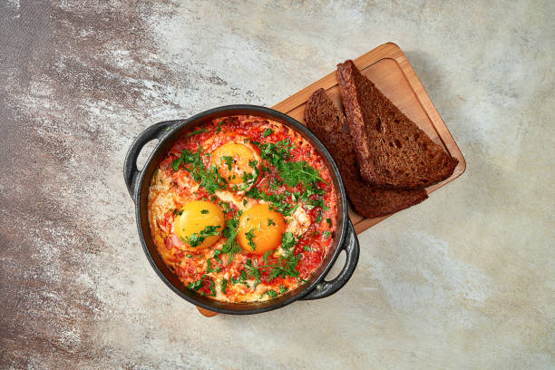 istock Israeli scrambled eggs shakshuka with tomatoes and onions. Close-up, selective focus 1439708449