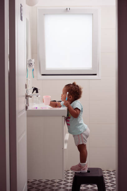 istock Little girl brushing teeth, rinse her mouth. 1439708586