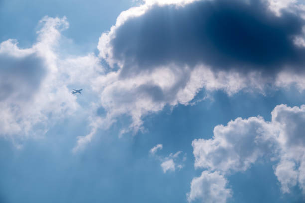 istock Beautiful cloudy and dramatic sky. Flying plane in sky. 1439709128