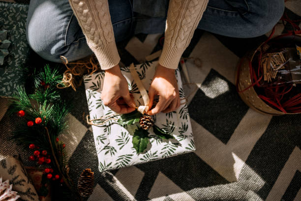 istock Unrecognisable woman wrapping christmas gift 1439710211