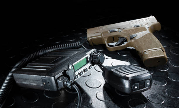 istock Semi-auto pistol and emergency radio 1439714085
