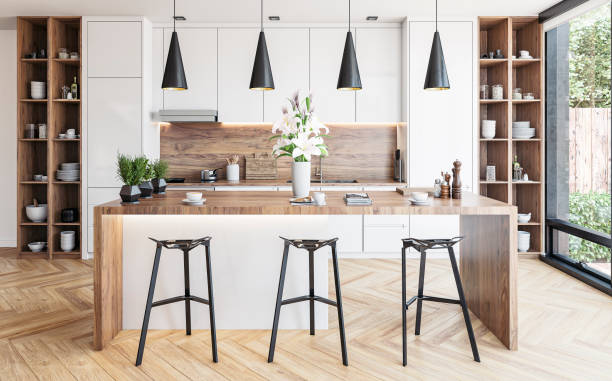 Modern white kitchen with rectangular breakfast kitchen island with stools stock photo