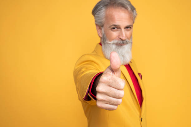 istock Happy well dressed gentleman having photoshooting in studio 1439715324