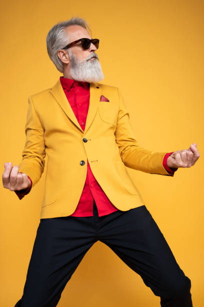 istock Happy well dressed gentleman having photoshooting in studio 1439715339