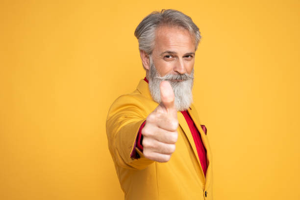 istock Happy well dressed gentleman having photoshooting in studio 1439715350