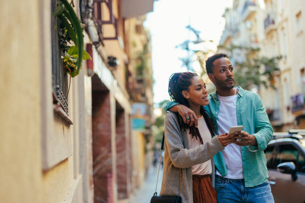 istock Affectionate couple with smartphone on street. 1439715463